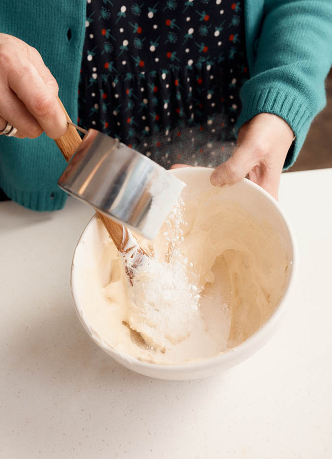 Kate adds icing sugar to butter to make buttercream
