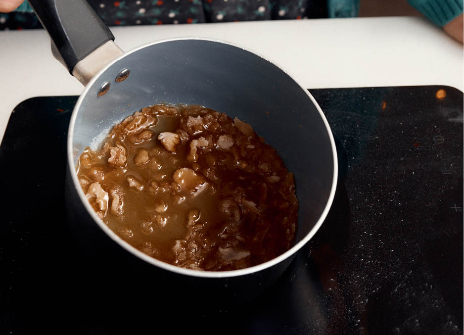 Making caramel to create walnut brittle 