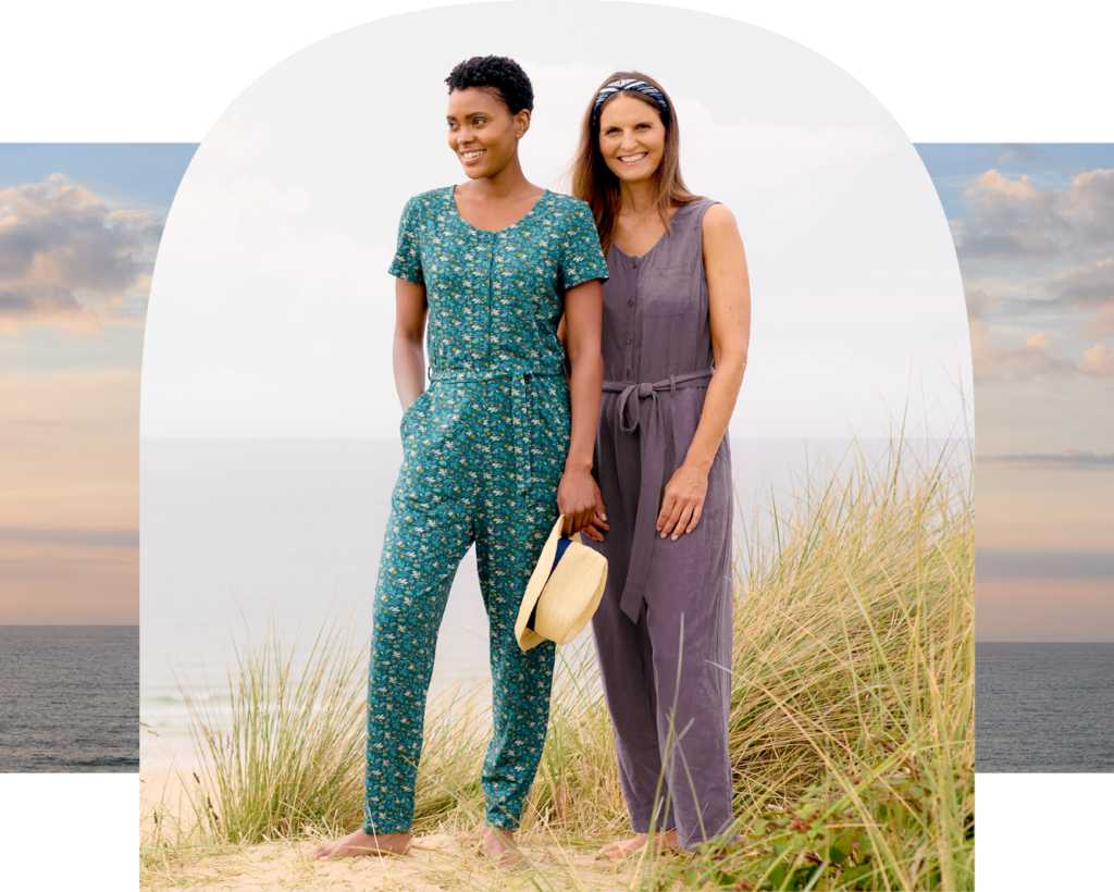 Women wear Seasalt Cornwall summer jumpsuits on a beach